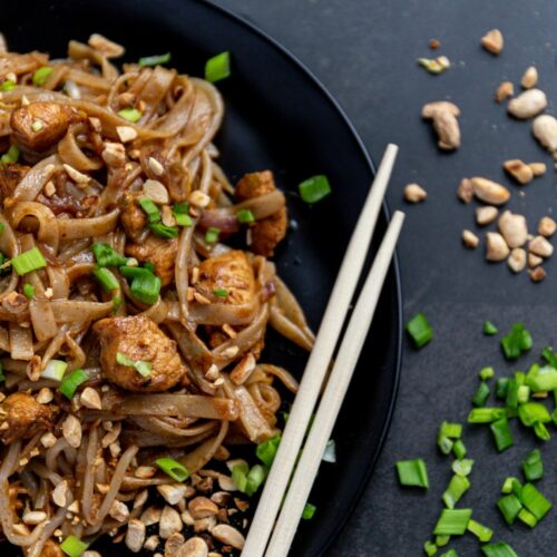 Asian Fusion Meets Leisurely Brunches - pad thai served on a black plate with wooden chopsticks