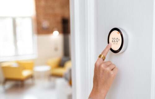 Luxury with Modern Convenience - man using a Nest-enabled Wi-Fi thermostat